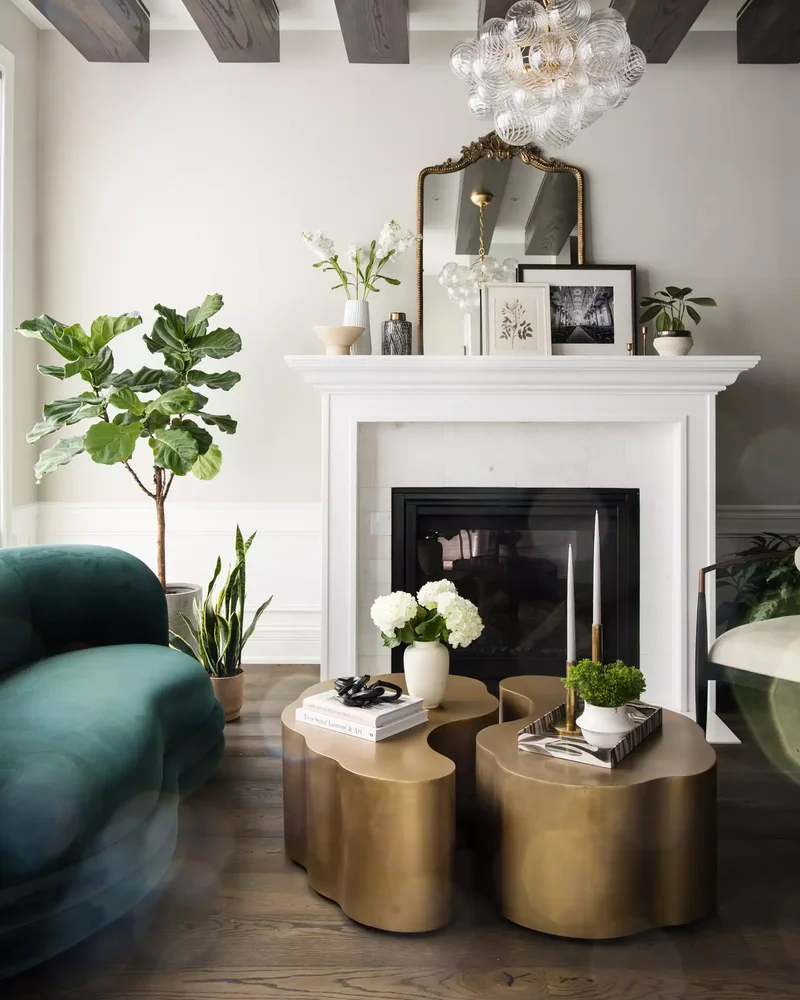 32 Living Room Mantle Decor Ideas That Add Style and Warmth 9 A Gilded Mirror, Art, and Greenery