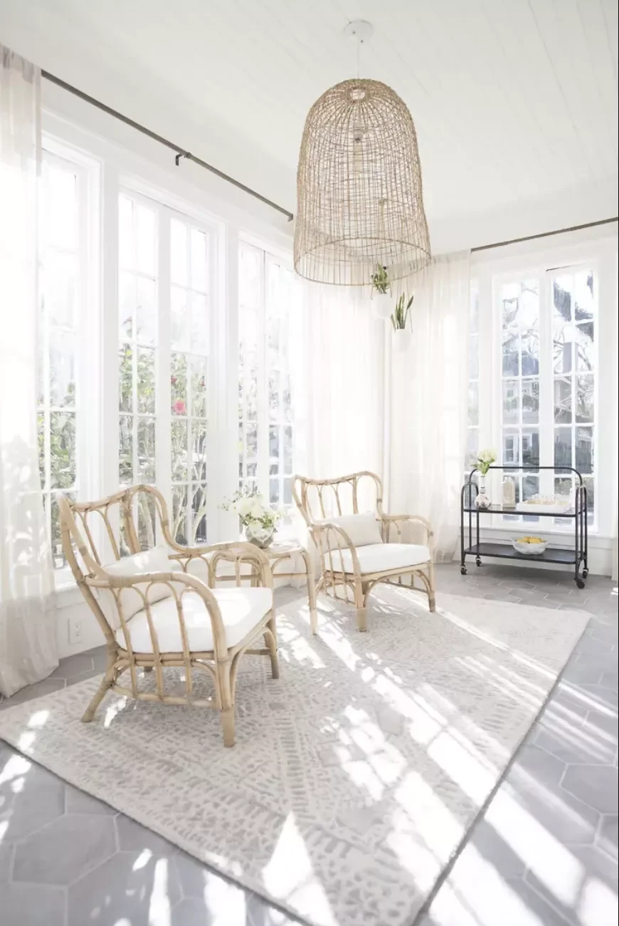 29 Stunning Three-Season Porch Ideas That'll Make You Want to Live Outdoors 1 A Minimalist Rattan-Filled Room