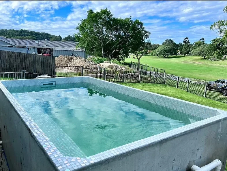 50 Semi-Inground Pool Designs That Transform Any Backyard Into Your Personal Paradise A Pool With Crystal Glass Tile