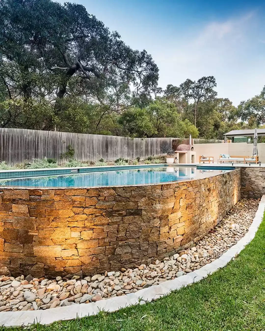 50 Semi-Inground Pool Designs That Transform Any Backyard Into Your Personal Paradise A Stone Facade