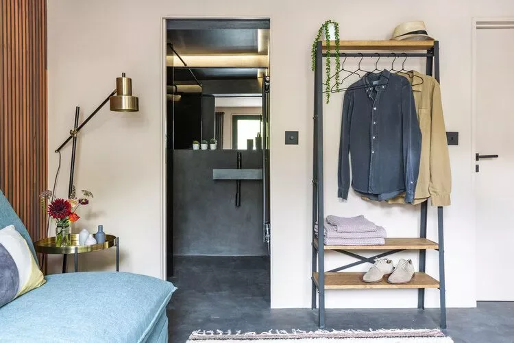 22 Smart Guest Bedroom Ideas That Make Small Spaces Feel Huge 18 Add a Clothes Rack