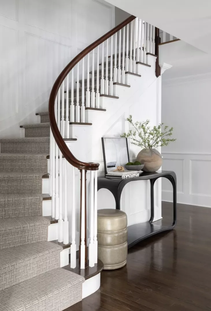32 Staircase Design Ideas That Transformed Homes This Year Add a Console Table to Semi-Spiral Stairs