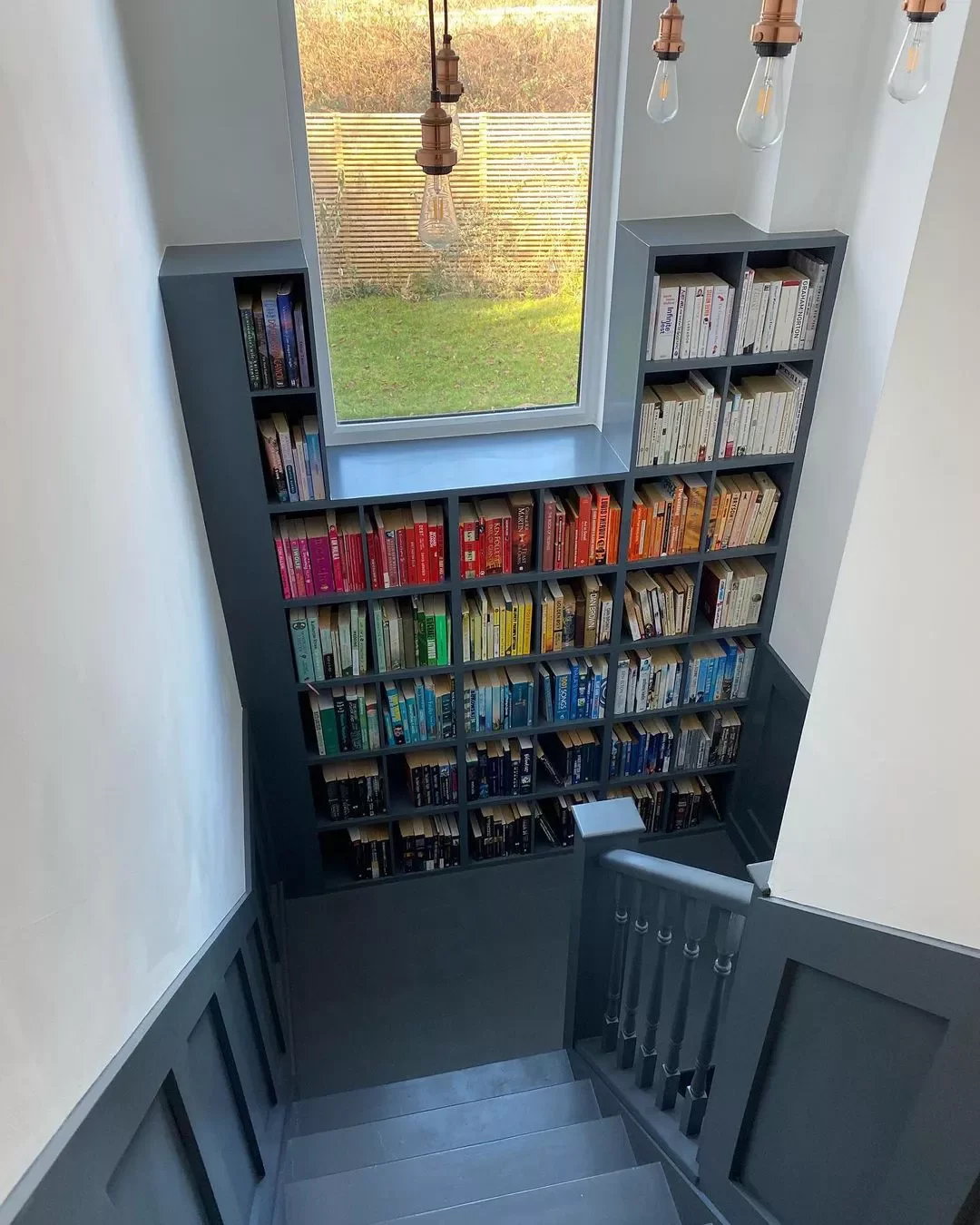 30 Creative Staircase Wall Decorating Ideas That Will Transform Your Space 16 Add in a Bookcase