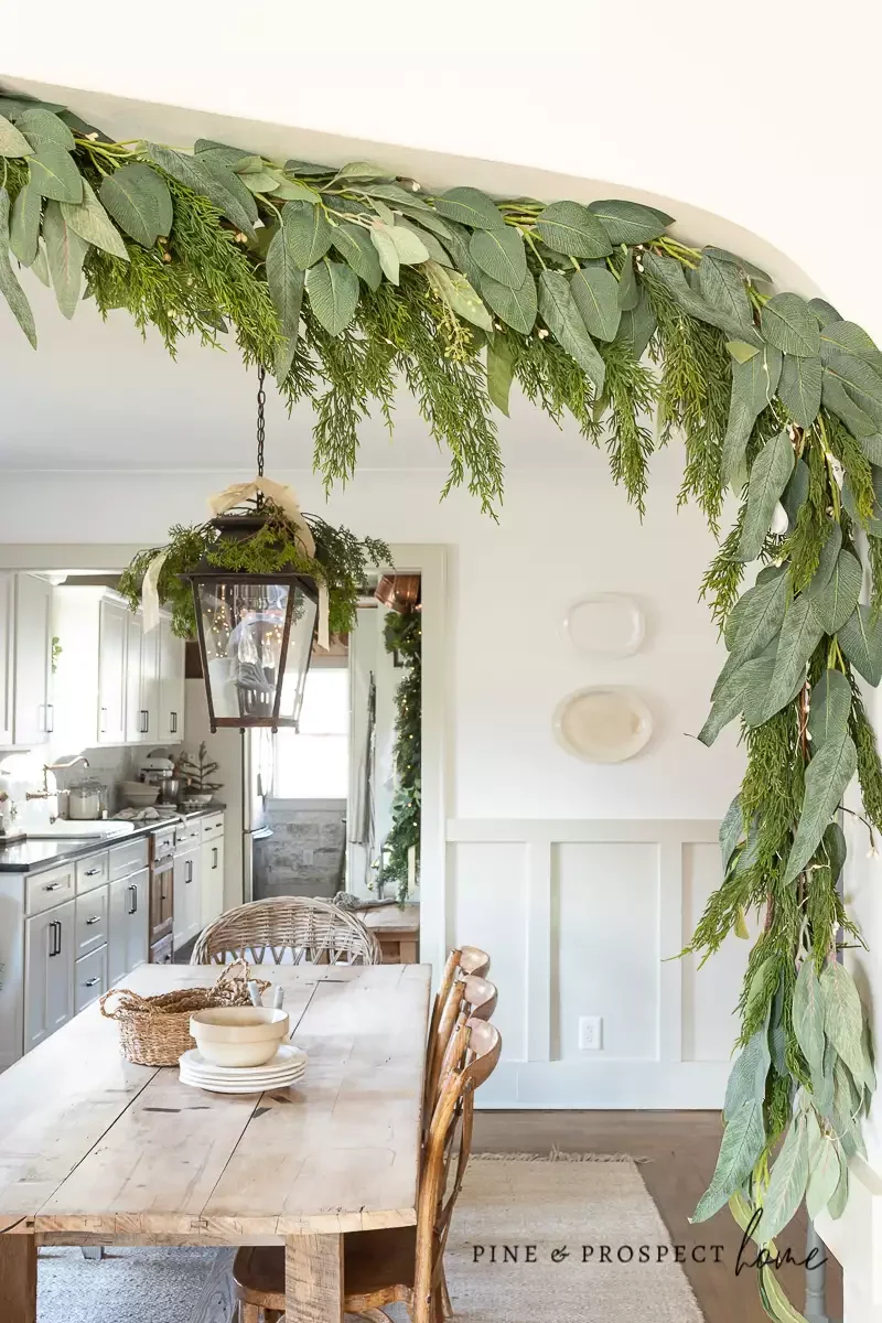 25 Stunning Christmas Lantern Ideas That'll Make Your Holiday Decor Absolutely Magical 6 Cedar Branches and Ribbon