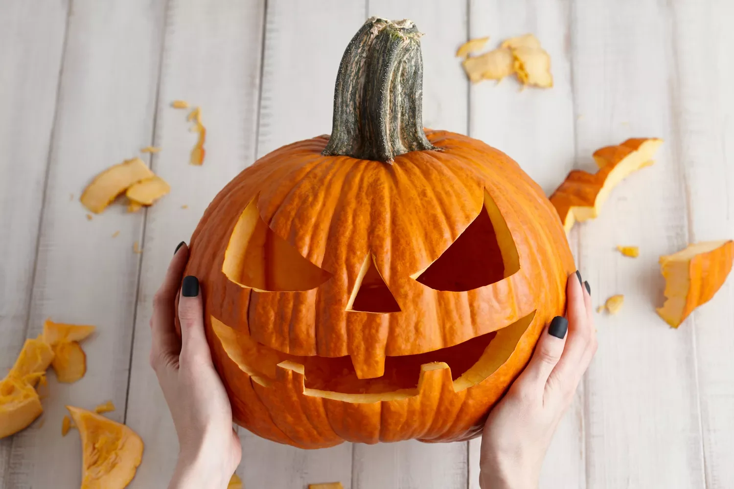 77 Creative Pumpkin Carving Ideas That'll Transform Your Fall Decorating Game 1 Classic Smiling Jack-o-Lantern