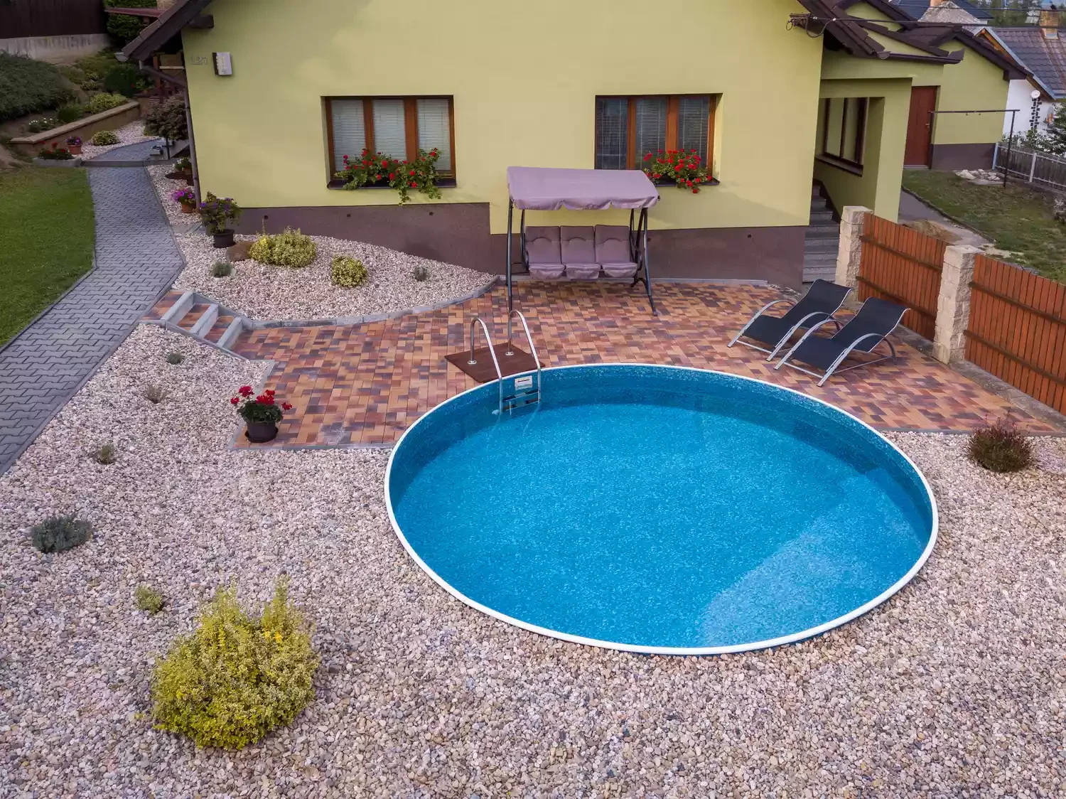 37 Brilliant Above-Ground Pool Deck Ideas That Won't Break Your Budget 31 Contrast Gravel With Bricks