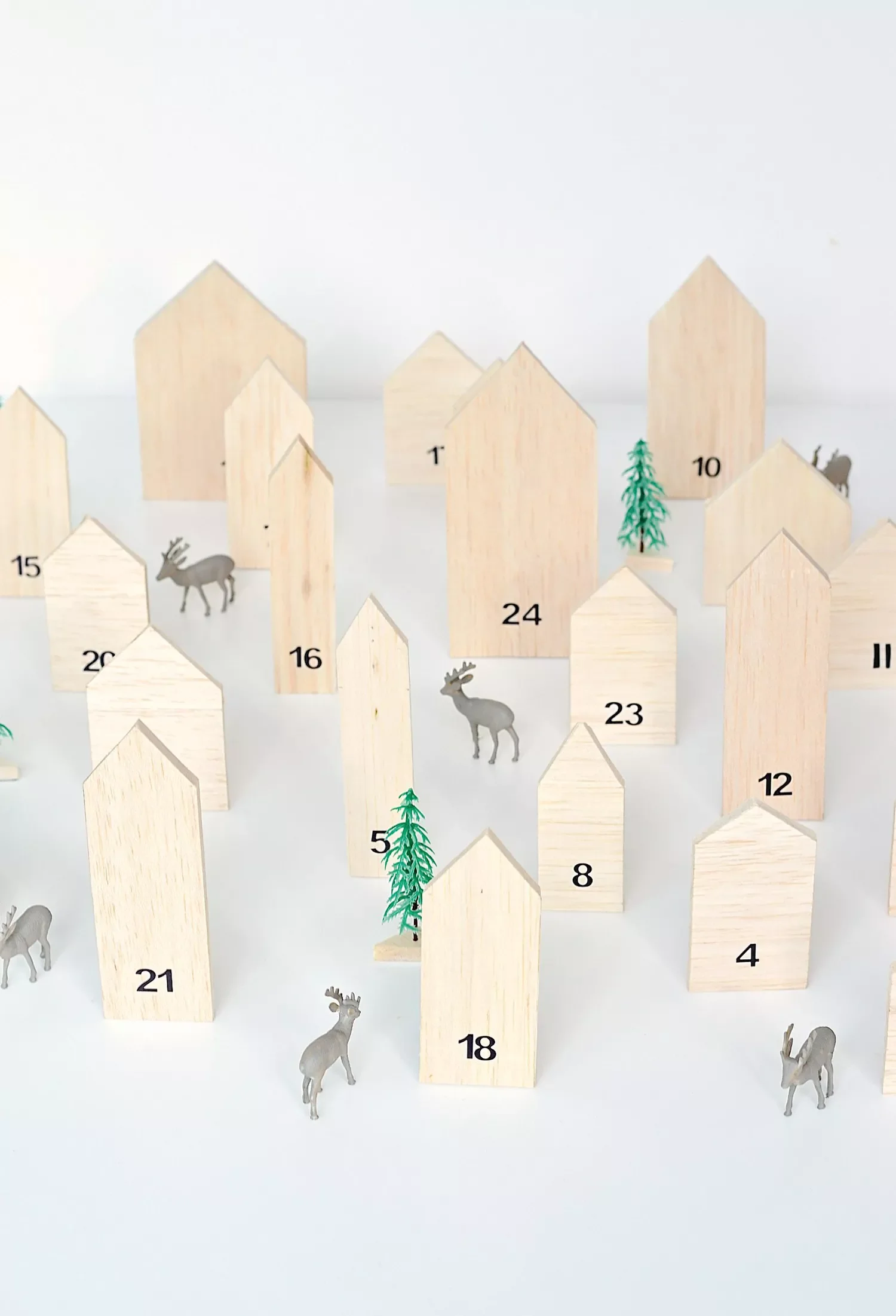 50 Stunning DIY Advent Calendar Ideas That Look Designer-Made 37 Create a Forest of Houses
