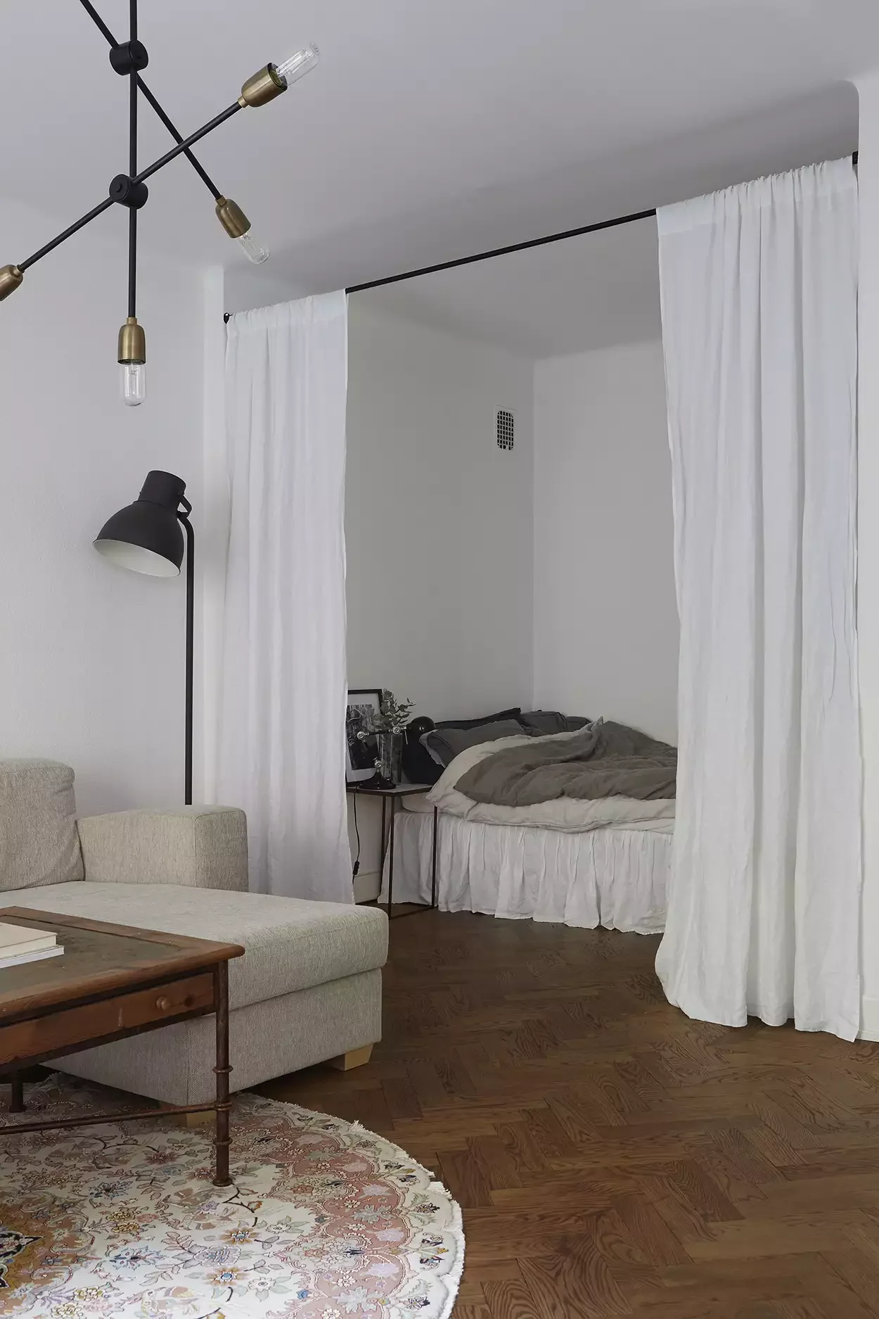 19 Affordable Ways to Transform Your Apartment Living Room 9 Curtain Off the Bed