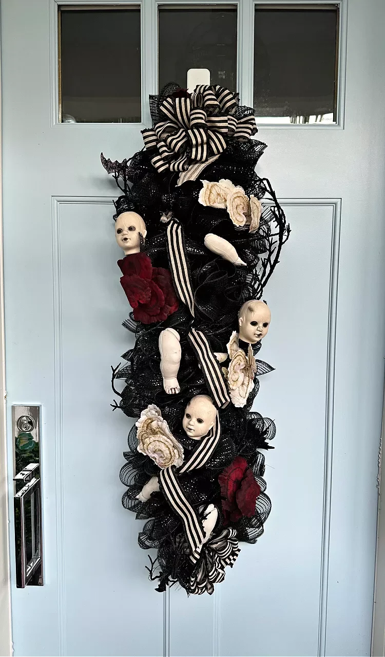 42 Quick Halloween Door Decorations You Can Create in Under an Hour 24 Dolls Head Door Hanger