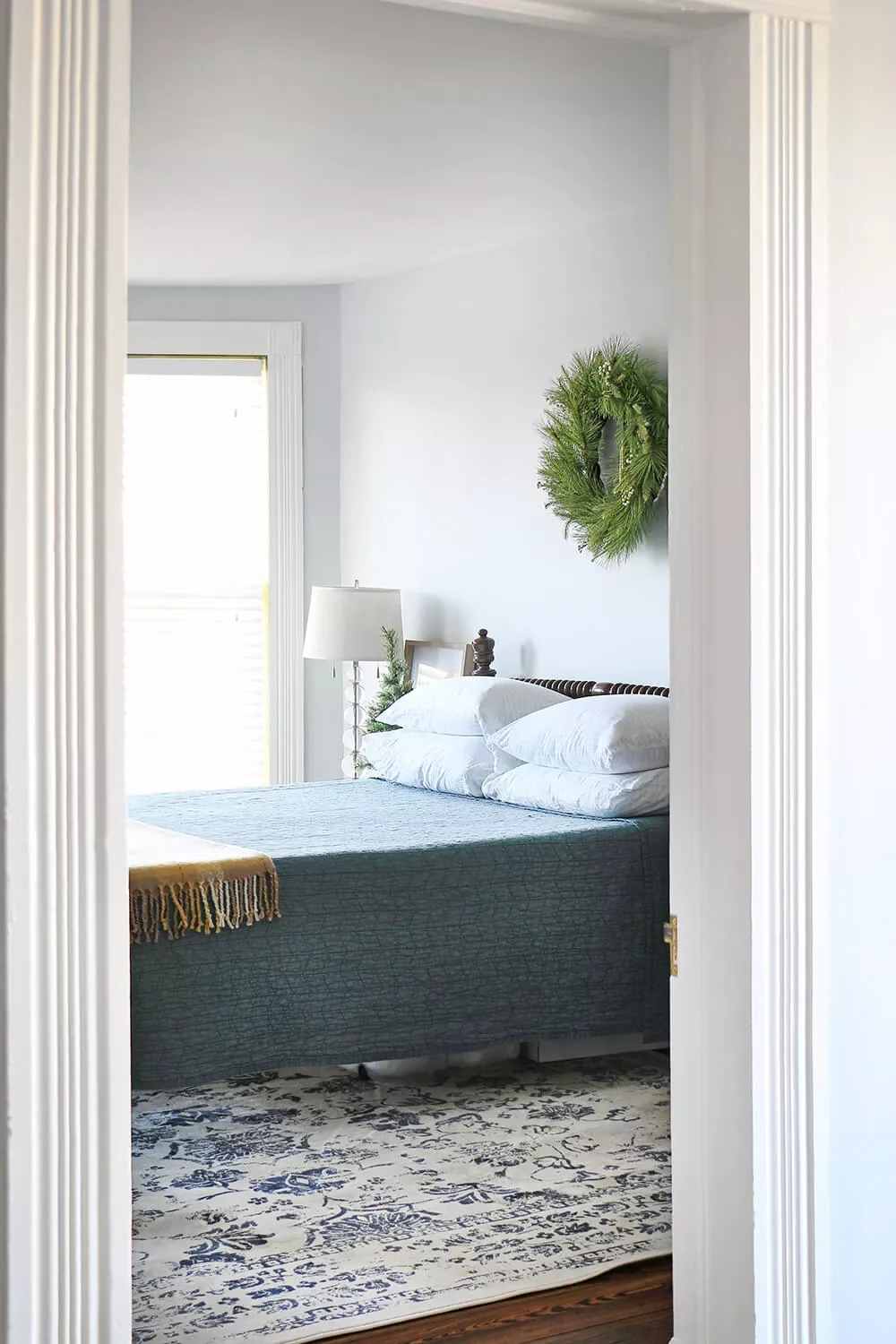32 Stunning Christmas Wall Decorating Ideas to Transform Your Home Into a Holiday Haven 8 Festive Wreath Above the Bed