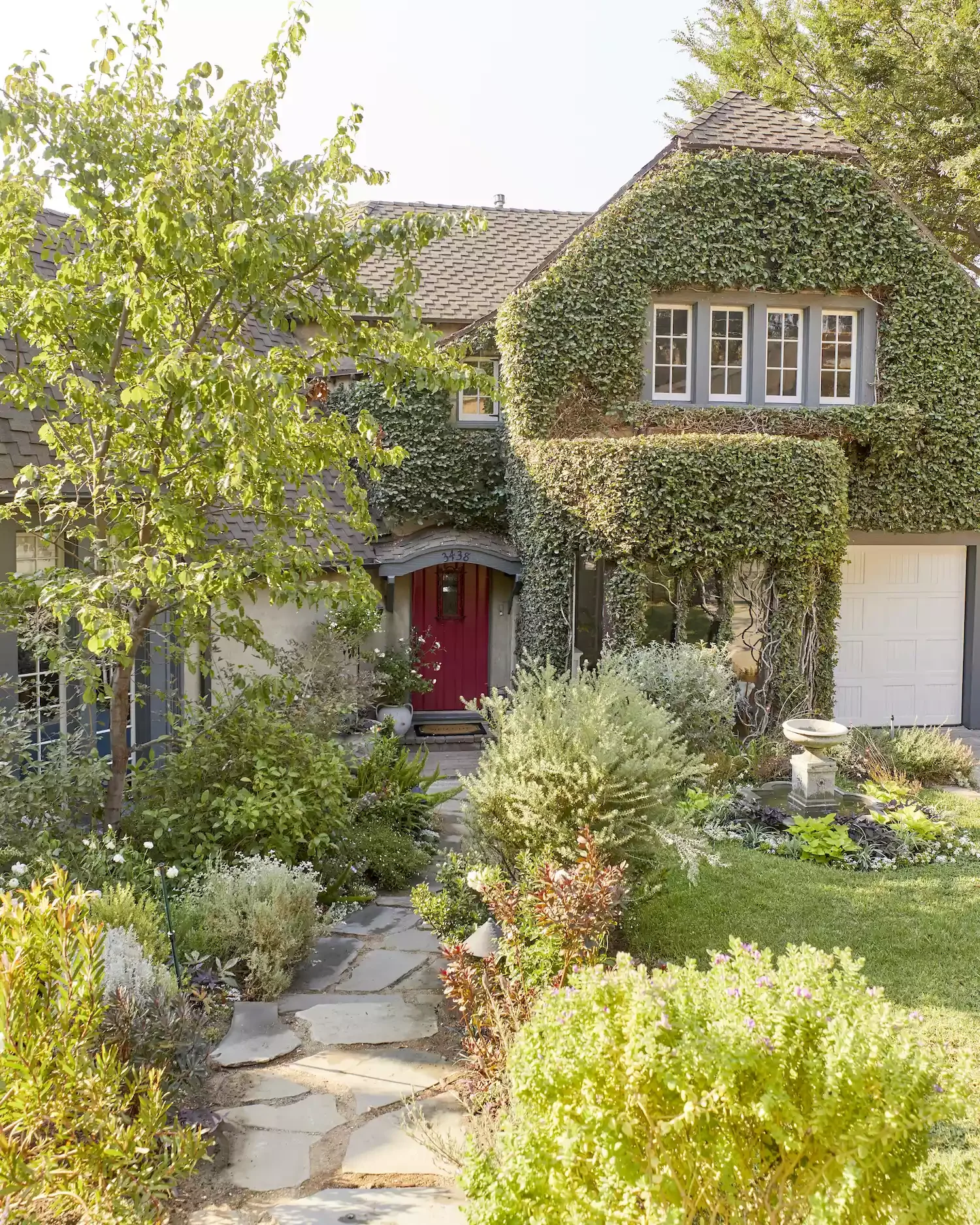 82 Stunning Front Yard Landscaping Ideas to Transform Your Home's Curb Appeal This Spring Flourishing Tudor-Style Front Yard