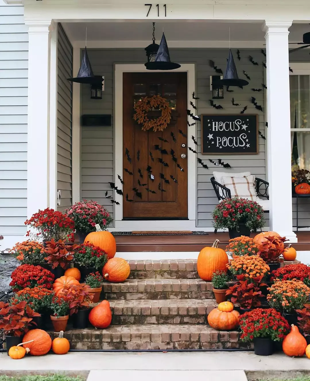 52 Autumn Front Porch Ideas That Will Transform Your Home's Entrance This Fall 36 Go Monochrome With Orange Pumpkins and Mums