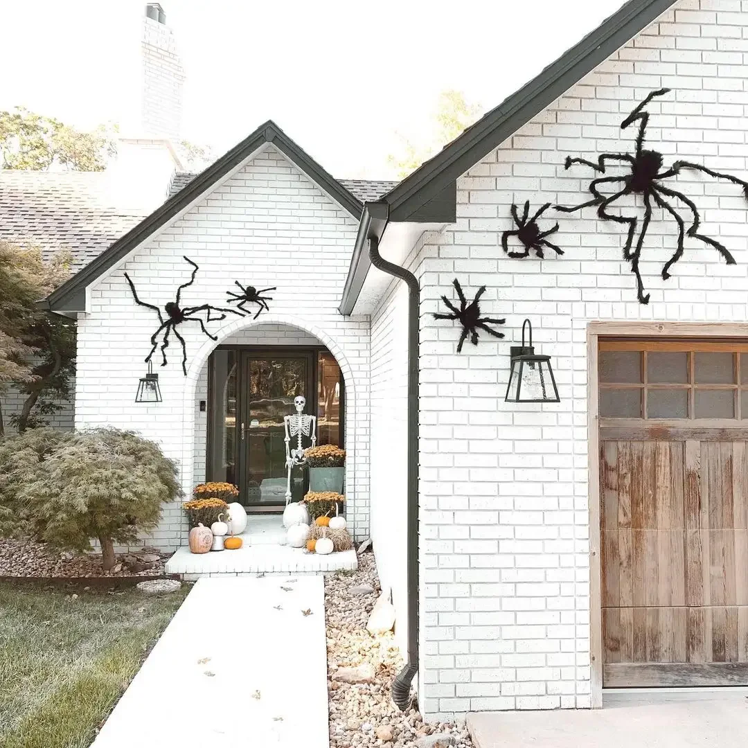 33 Spooktacular Halloween Front Porch Ideas That'll Make Your Home the Neighborhood's Must-See Destination 8 Hang Scary Spiders