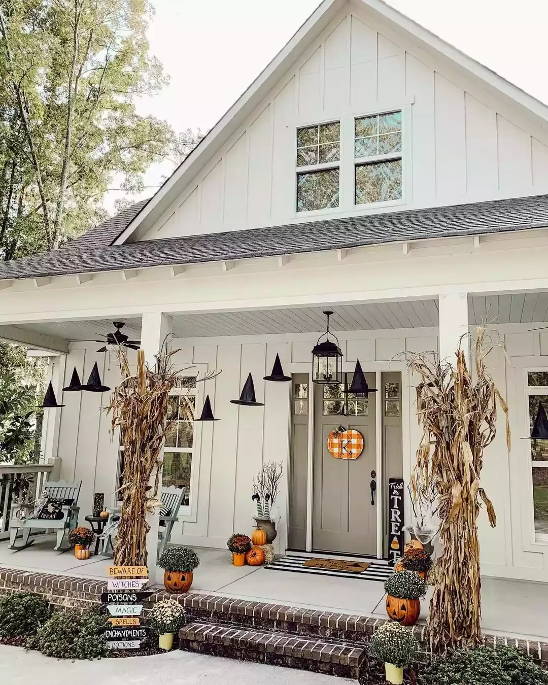 52 Autumn Front Porch Ideas That Will Transform Your Home's Entrance This Fall 14 Hang Witches Hats