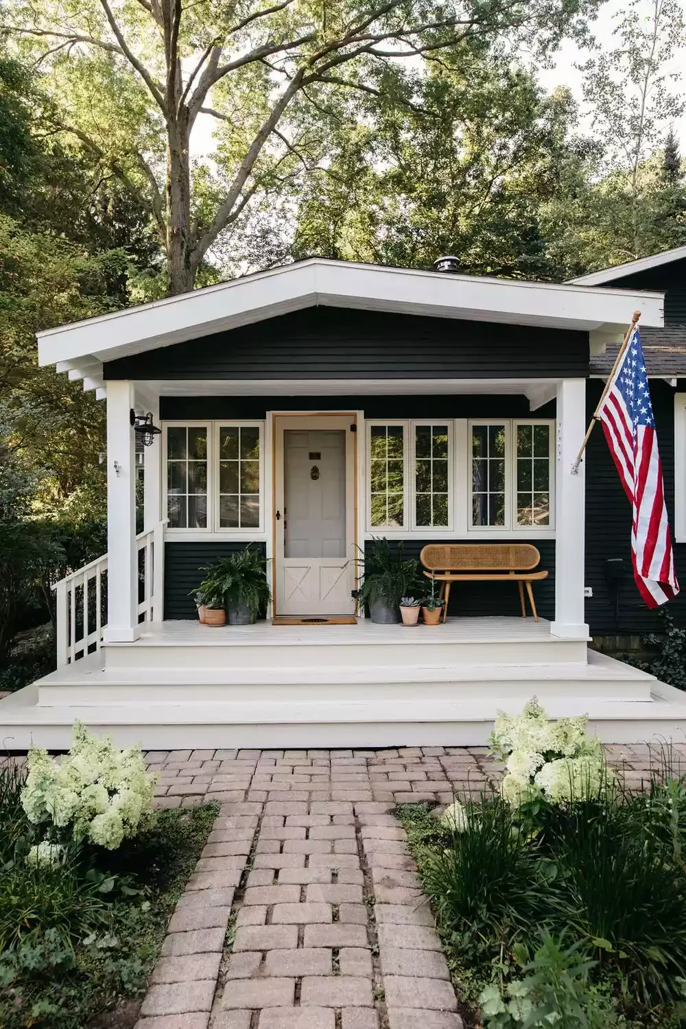38 Charming Farmhouse Porch Ideas That Create the Perfect Welcome 17 Hang a Flag