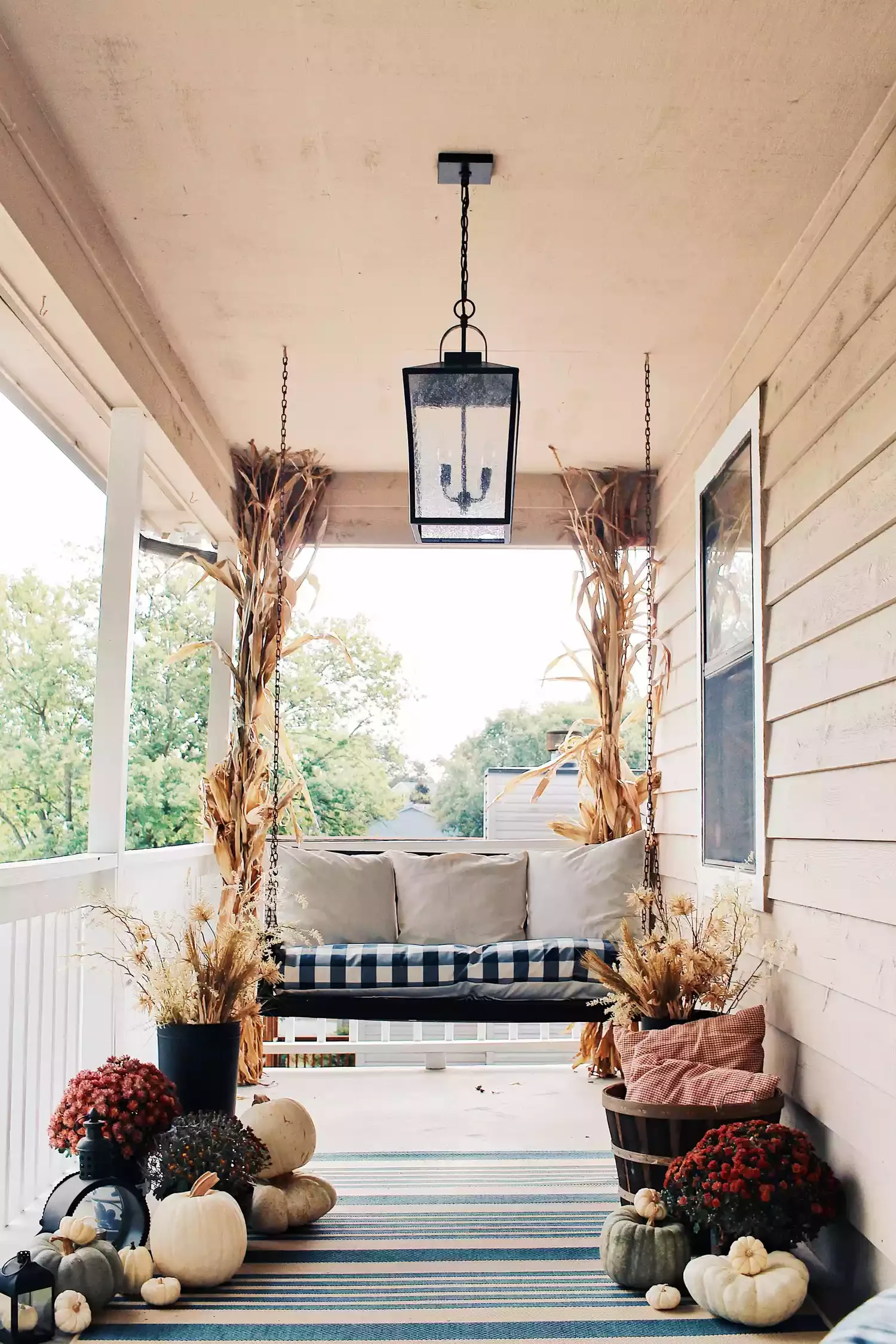 38 Charming Farmhouse Porch Ideas That Create the Perfect Welcome 5 Hang a Swing