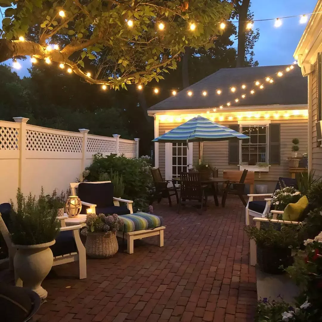 30 Beautiful Ways to Transform Your Patio with String Lights 19 Incorporate a Tree