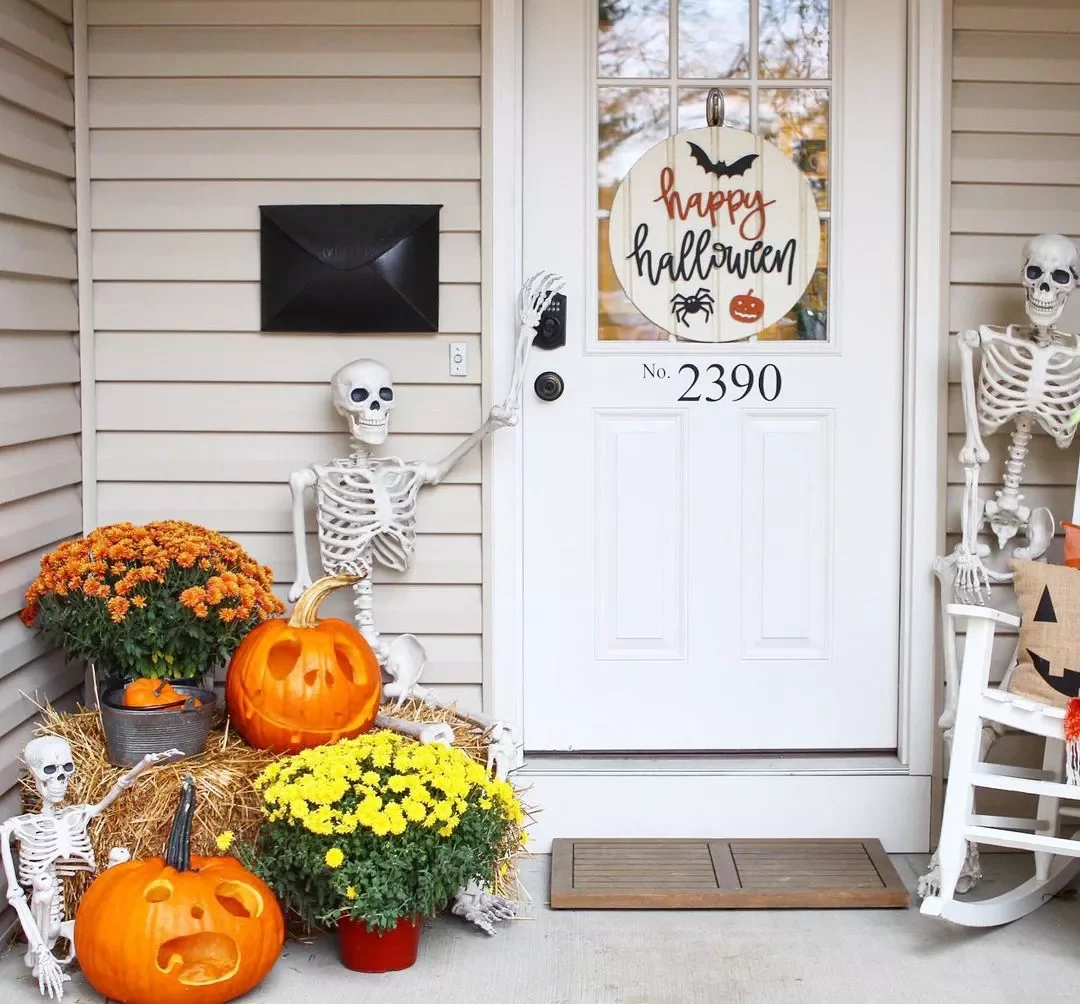 33 Spooktacular Halloween Front Porch Ideas That'll Make Your Home the Neighborhood's Must-See Destination 3 Make Your Skeletons Gesture