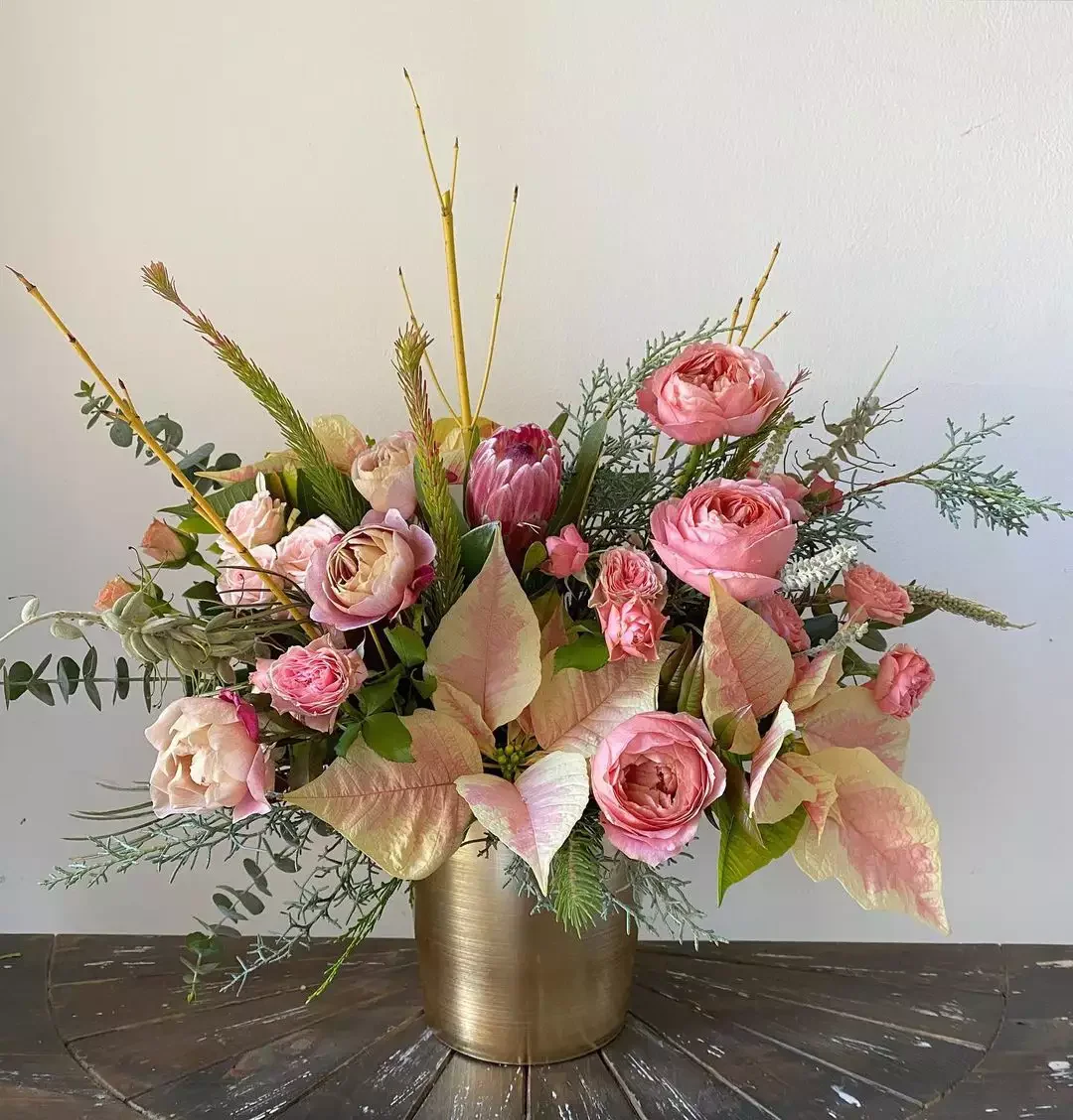 21 Stunning Poinsettia Display Ideas to Transform Your Holiday Home 10 Mixed Floral Arrangement
