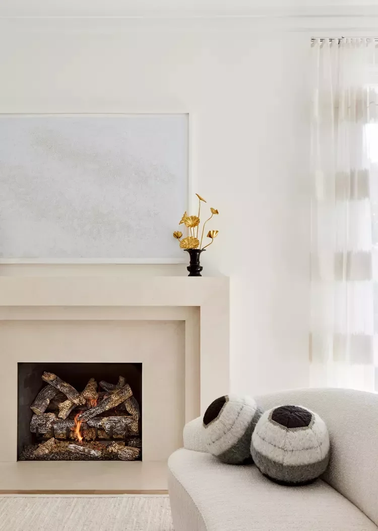 32 Living Room Mantle Decor Ideas That Add Style and Warmth 15 Monochromatic Mantel With Floral Pop