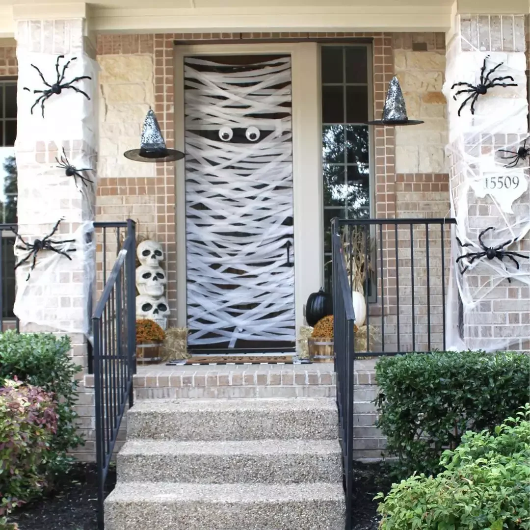 33 Spooktacular Halloween Front Porch Ideas That'll Make Your Home the Neighborhood's Must-See Destination 17 Mummify Your Door