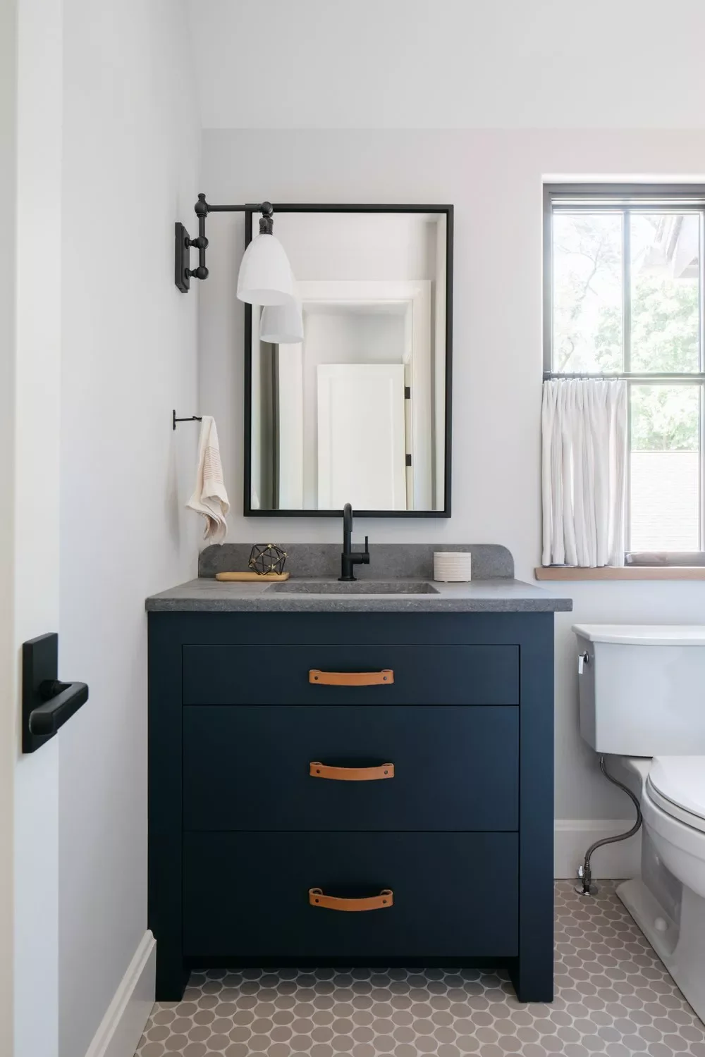 25 Compact Bathroom Vanity Ideas That Maximize Style and Storage 8 Navy Blue Vanity With Leather Pulls