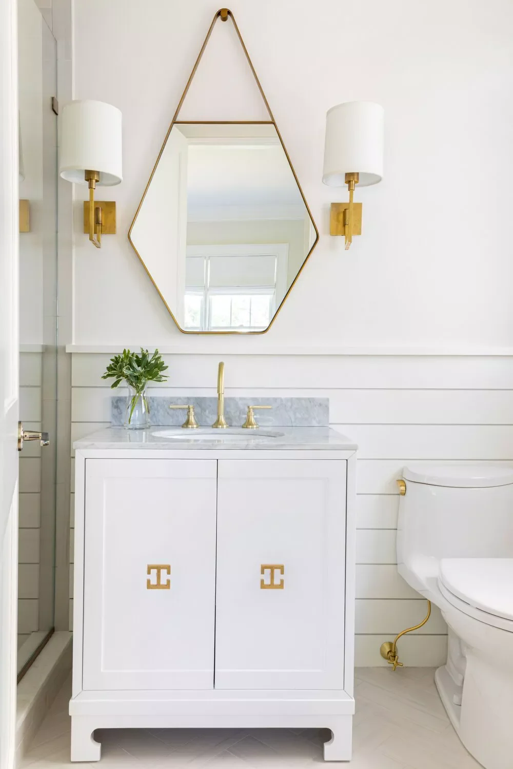 22 Simple White Bathroom Ideas That Make a Big Impact Opt for a Decorative Mirror