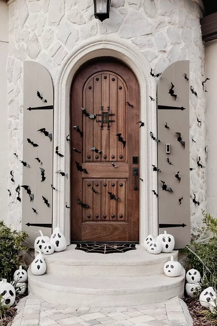 33 Spooktacular Halloween Front Porch Ideas That'll Make Your Home the Neighborhood's Must-See Destination 33 Paint Ghoulish Ghost Gourds and Pumpkins