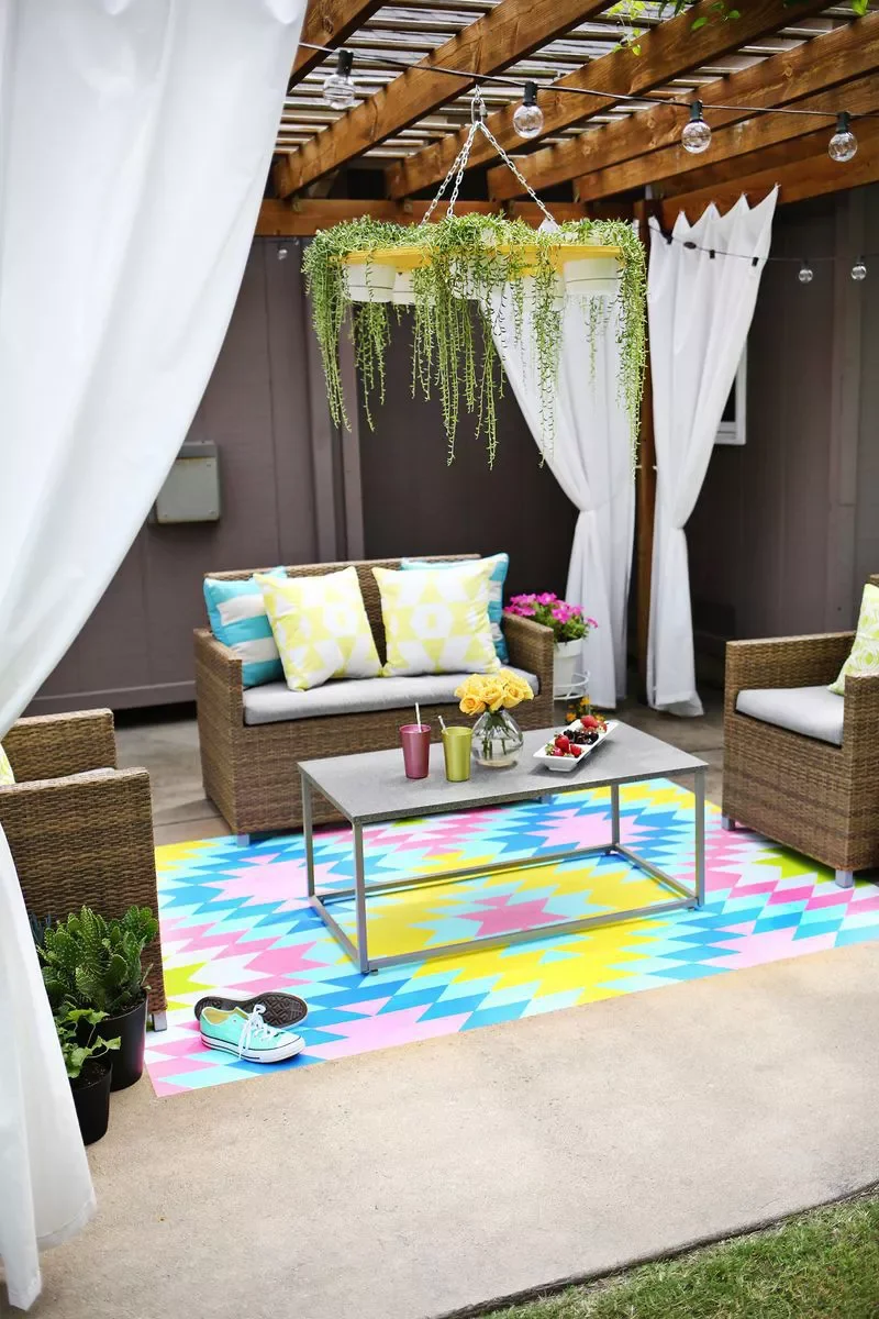 30 Budget-Friendly Ways to Transform Your Concrete Patio 29 Paint on an Accent Rug