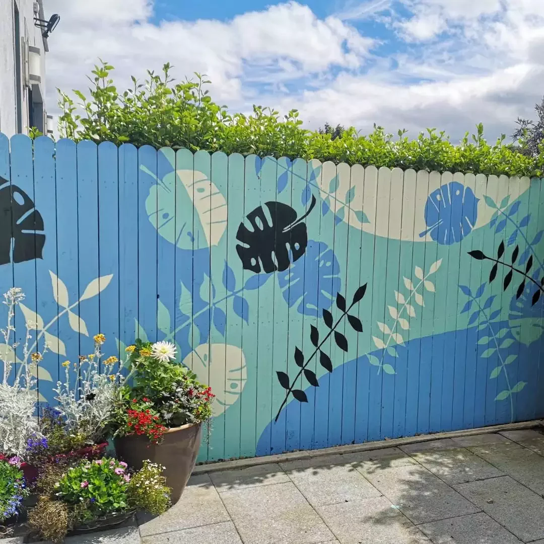 37 Budget Backyard Ideas That Create a Stunning Retreat Paint or Commission a Fence Mural