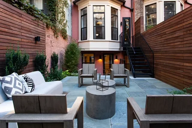 26 Stunning Stone Patio Designs Perfect for Every Outdoor Space 22 Patio With Bluestone and Wooden Fencing