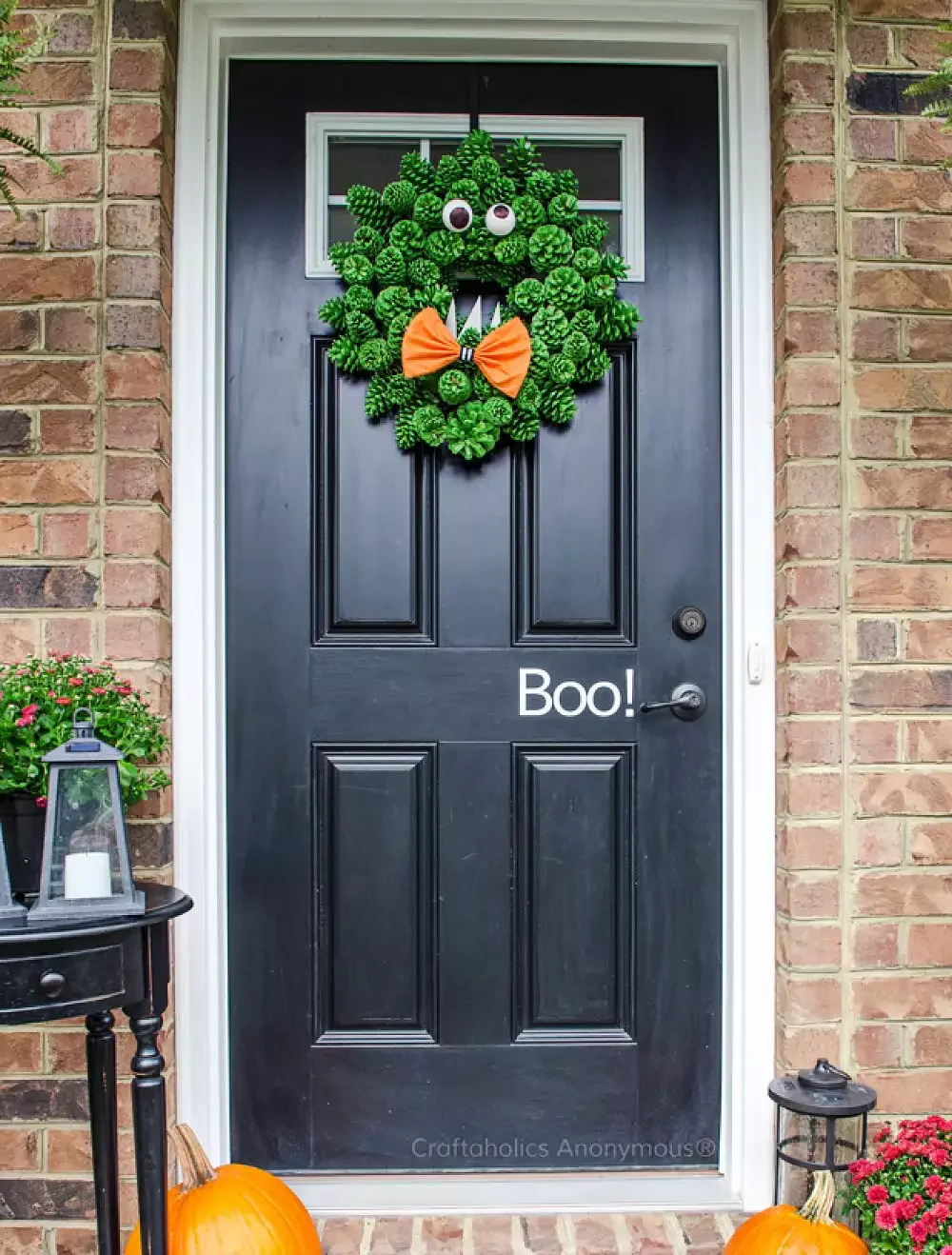 42 Quick Halloween Door Decorations You Can Create in Under an Hour 34 Pine Cone Monster Wreath