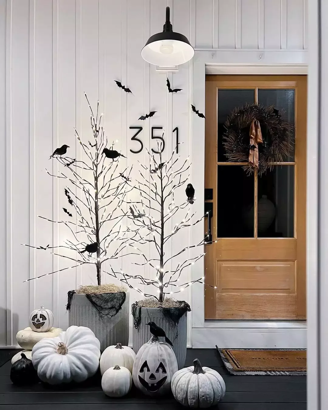 33 Spooktacular Halloween Front Porch Ideas That'll Make Your Home the Neighborhood's Must-See Destination 20 Put Up Light-Up Trees