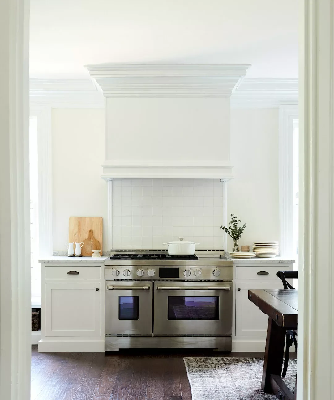 59 Timeless White Kitchen Design Ideas That Never Go Out of Style Sculptural White Range Hood