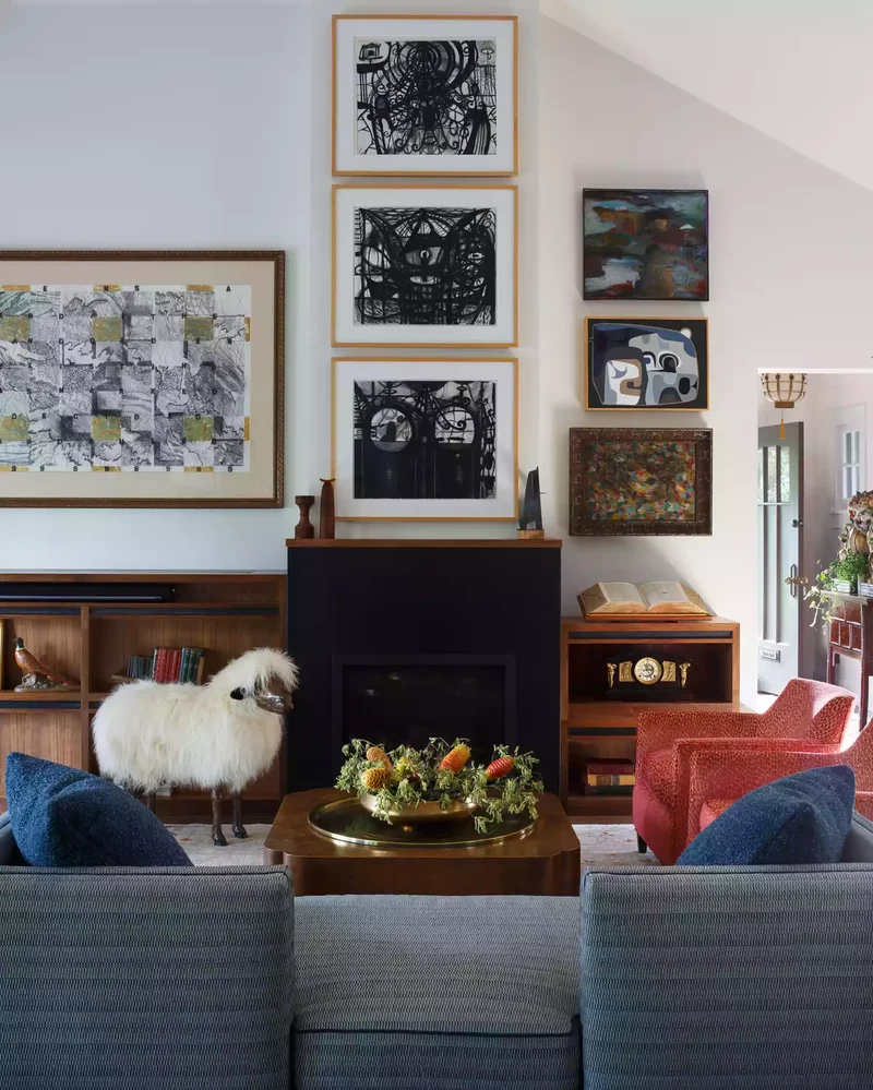 32 Living Room Mantle Decor Ideas That Add Style and Warmth 27 Stacked Black-and-White Photography