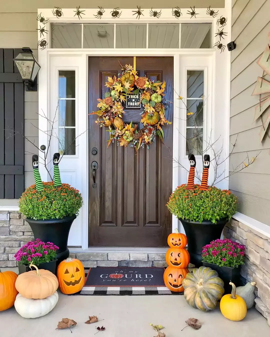 33 Spooktacular Halloween Front Porch Ideas That'll Make Your Home the Neighborhood's Must-See Destination 6 Stick Some Witch Legs In Your Mums