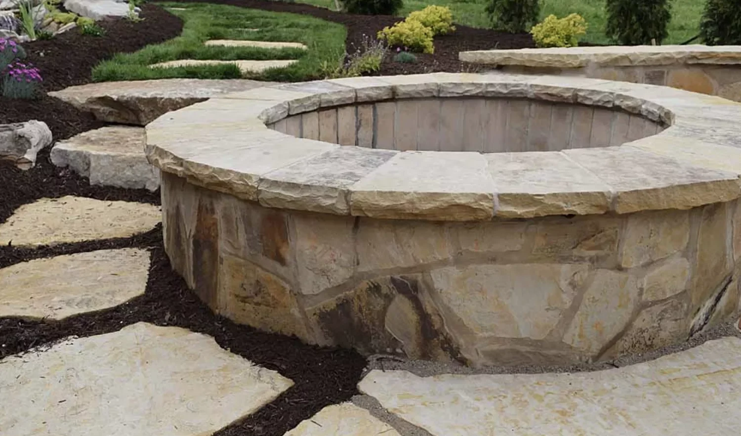 21 Beautiful Stone Fire Pit Designs That Will Transform Your Backyard 10 Stone Fire Pit Surrounded by Patio Pavers
