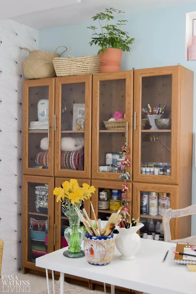 15 Creative Sewing Room Ideas to Transform Your Craft Space Store Supplies in a Glass-Front Cabinet