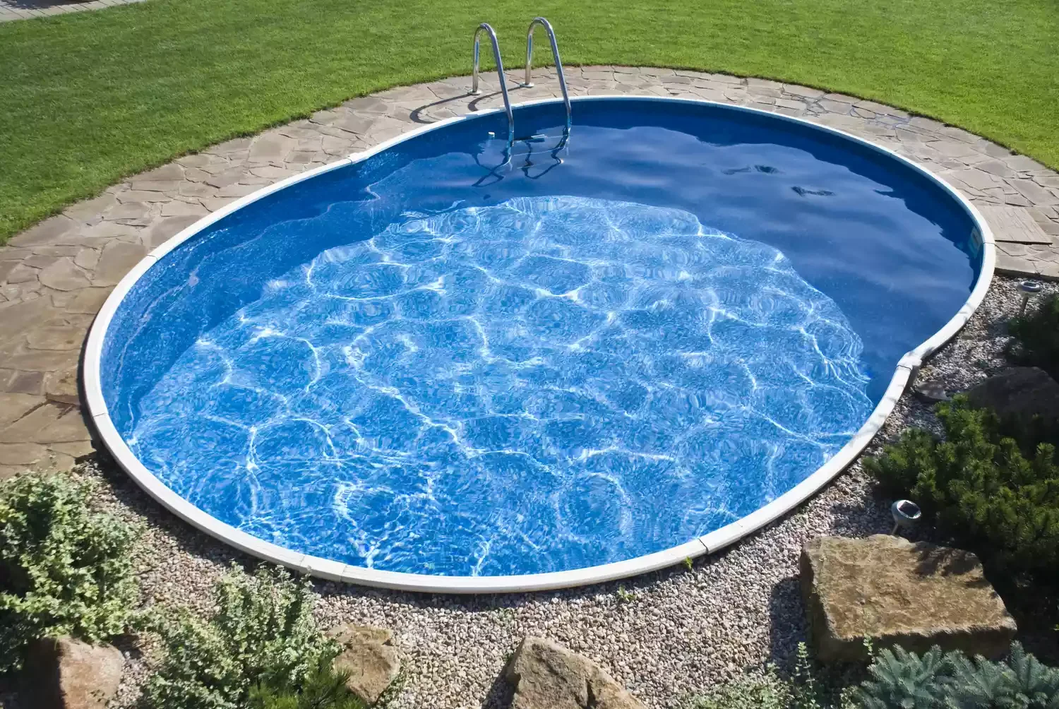 37 Brilliant Above-Ground Pool Deck Ideas That Won't Break Your Budget 34 Try Stone Pavers, Gravel, and Greenery