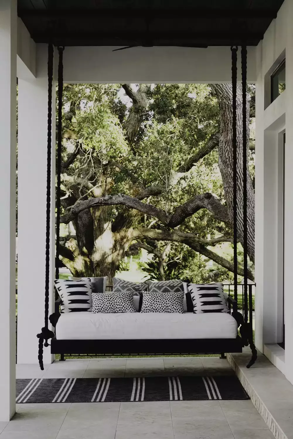 62 Warm and Inviting Front Porch Design Ideas That Welcome Everyone Home 7 Try a Modern Porch Swing