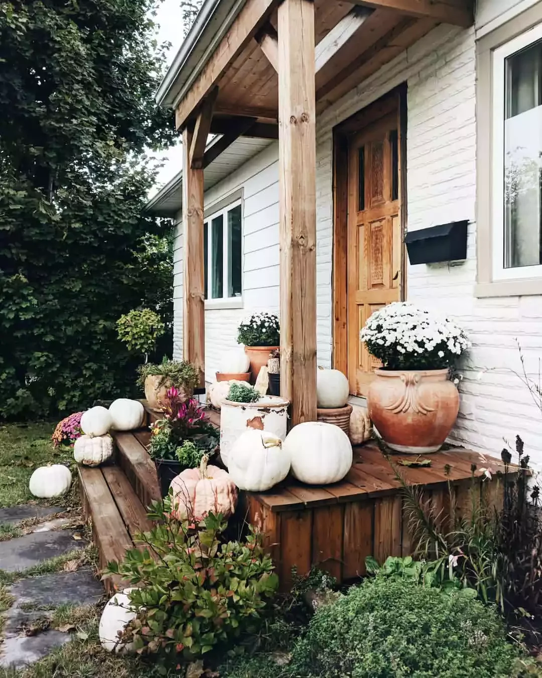 38 Charming Farmhouse Porch Ideas That Create the Perfect Welcome 19 Use Terracotta Pots