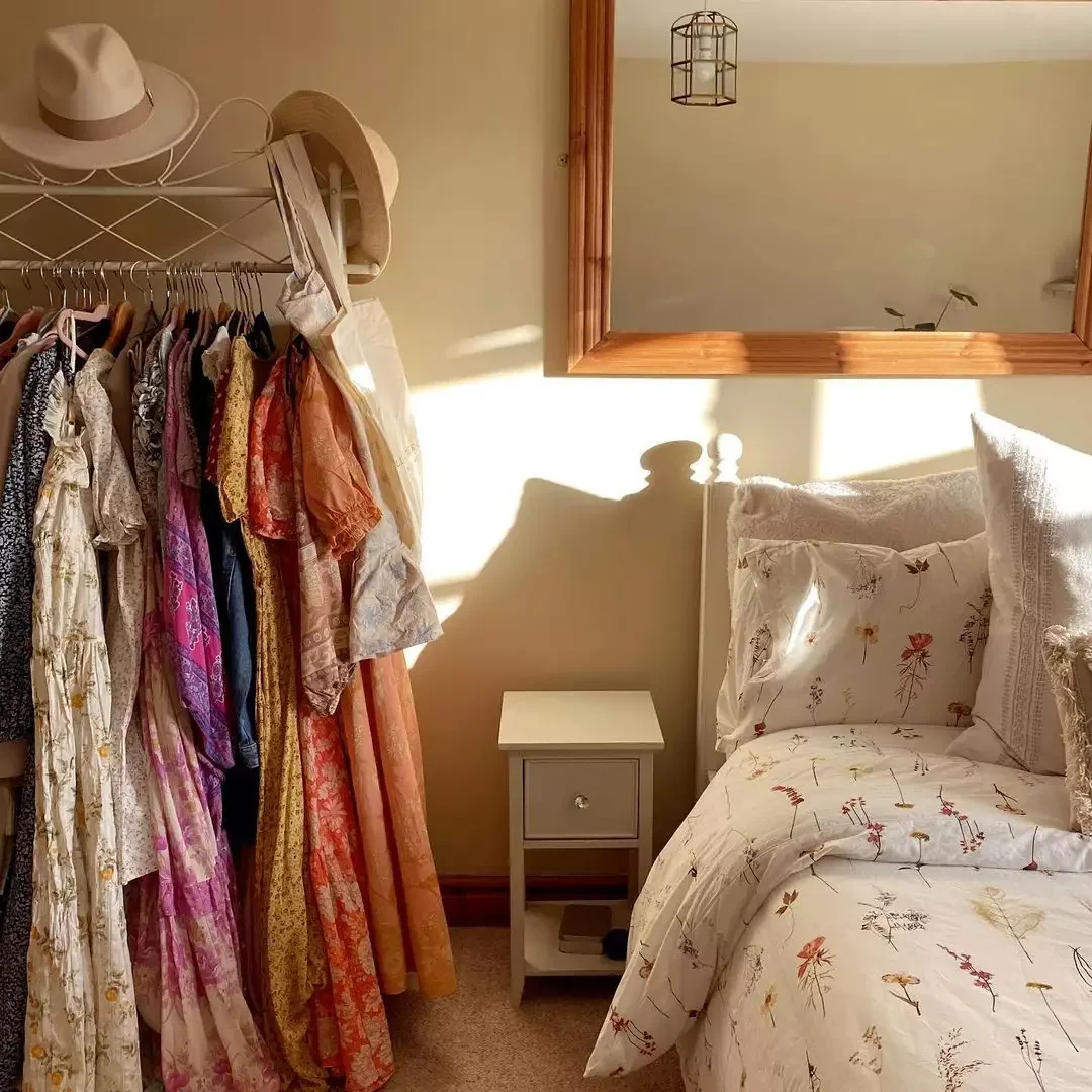 34 Dreamy Cottagecore Bedroom Ideas That Will Make You Want to Redecorate Tonight 3 Use a Clothing Rack