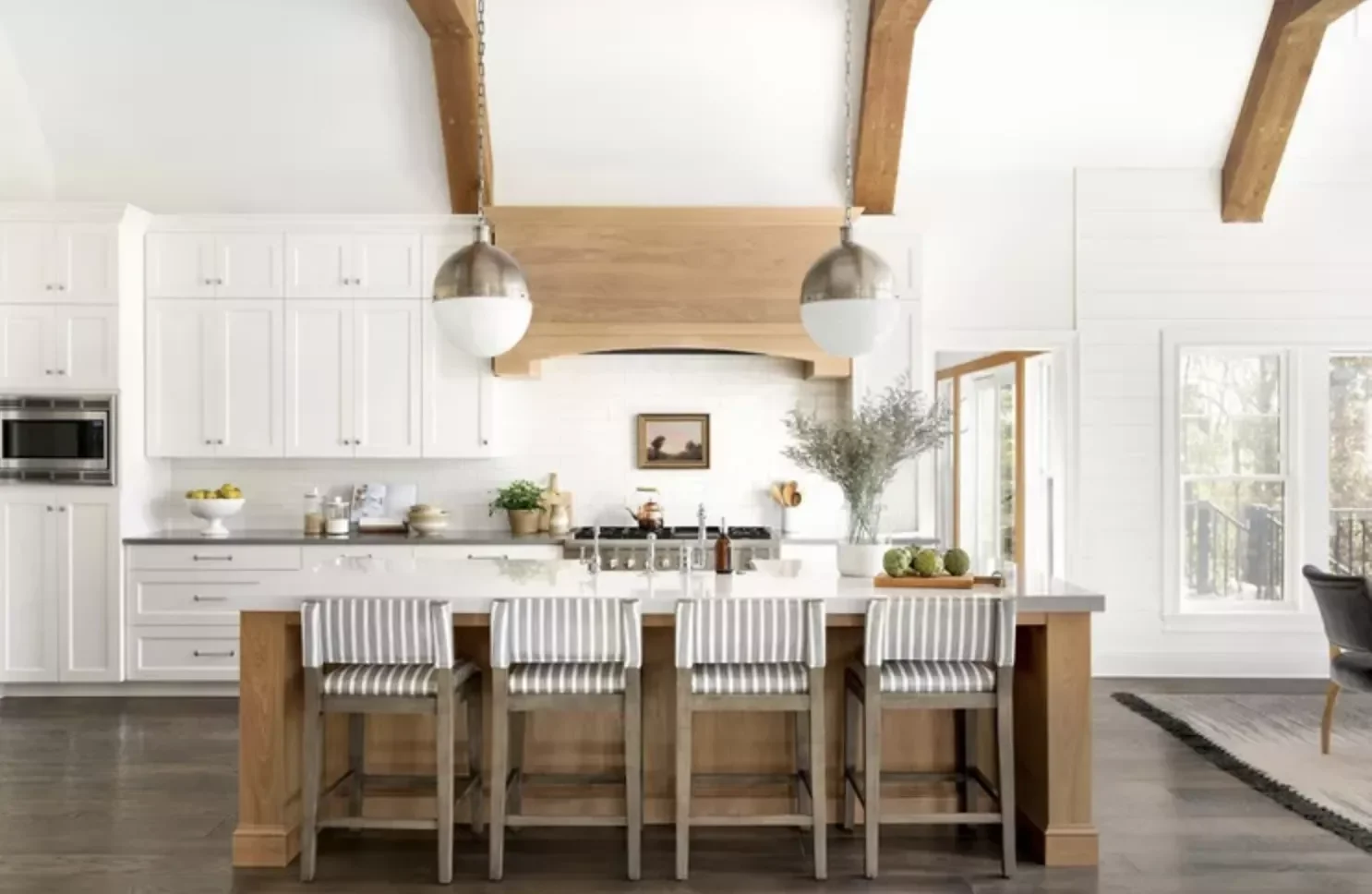 White Cabinets With a Wood Vent Hood and Beams