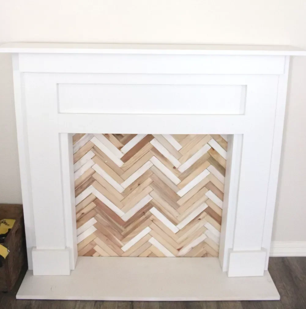 20 Creative DIY Fake Fireplace Projects You Can Build This Weekend 18 White Mantel With Herringbone