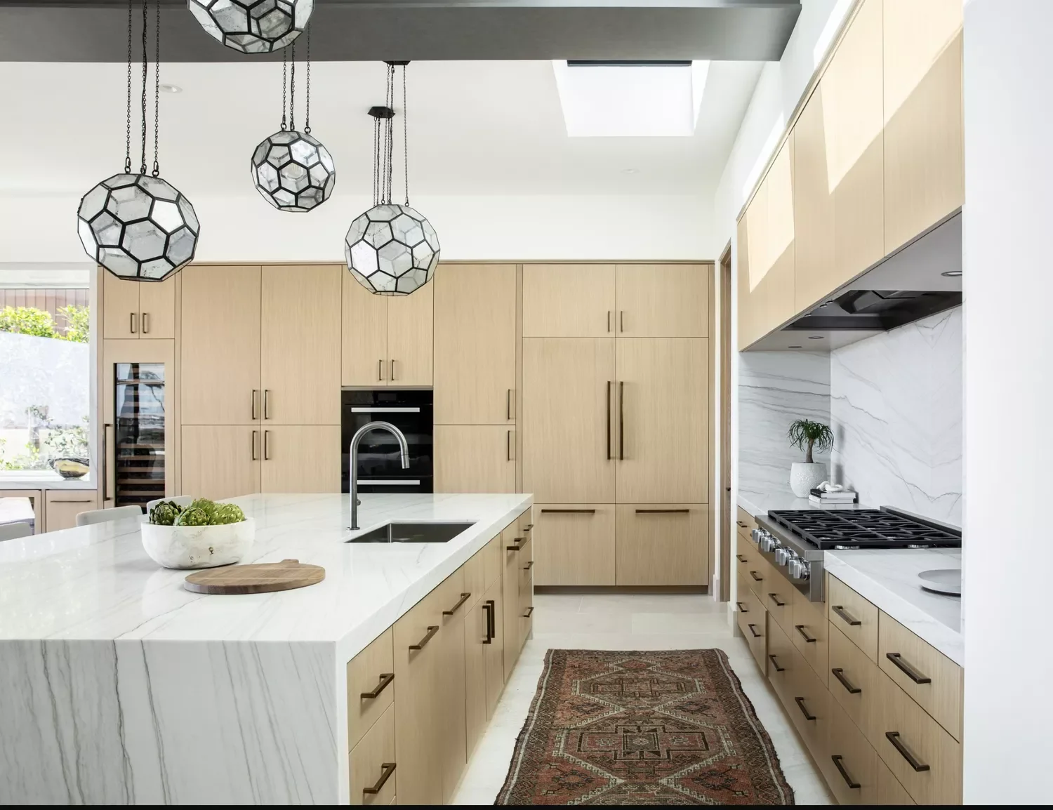 Wood Cabinets and a Marble Waterfall Island