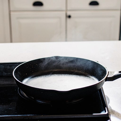 Heat Before Adding Oil

Before adding any oil to your cast iron skillet, you'll need to properly preheat the pan on medium heat for 5-7 minutes.

This vital step allows the iron's pores to open up, creating the perfect surface for oil absorption and preventing food from sticking. 

You'll know your pan is ready when you can feel the heat radiating above the surface by holding your hand 3 inches over it.